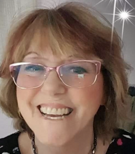 Smiling woman with glasses and star effect.