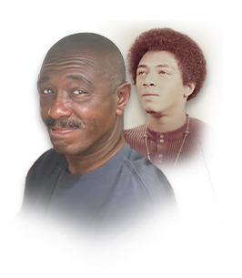 Man smiling beside youthful portrait