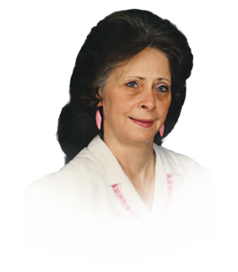 Smiling woman in white shirt with pink earrings