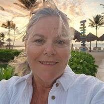 Woman smiling at tropical beach during sunset.