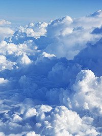 Fluffy white clouds against blue sky