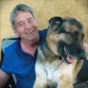 Smiling man with German Shepherd dog