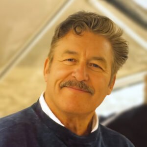 Smiling man with a mustache indoors