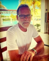 Man sitting at tropical outdoor restaurant