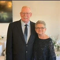 Elderly couple smiling at formal event