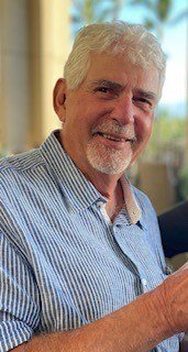 Smiling man enjoying a drink outdoors