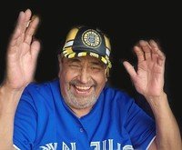 Smiling man wearing blue sports jersey and cap