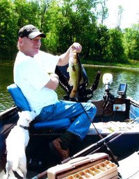 Man fishing on boat, holding caught fish