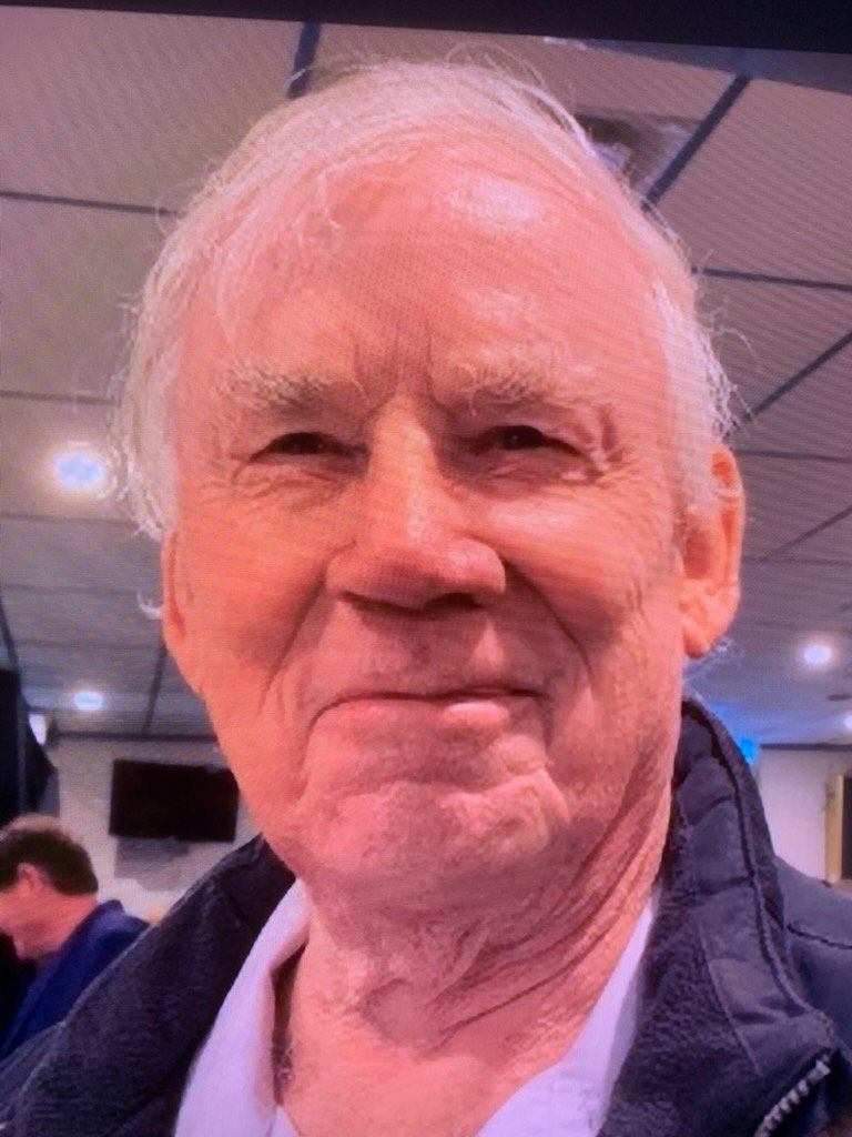 COOPER, John Michael cooper Smiling elderly man indoors with jacket.