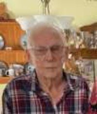 Elderly person in plaid shirt, home setting