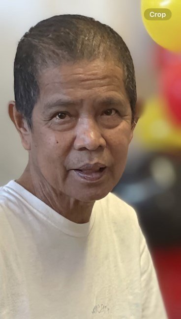 Older man in white shirt, colorful blurred background.
