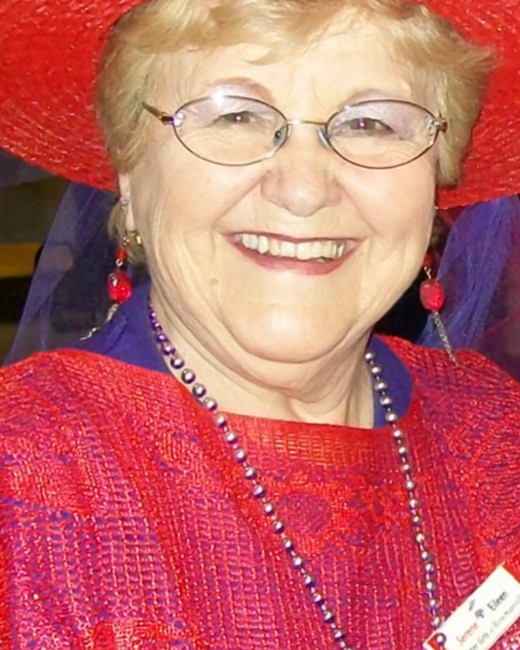 Smiling woman in red hat and outfit