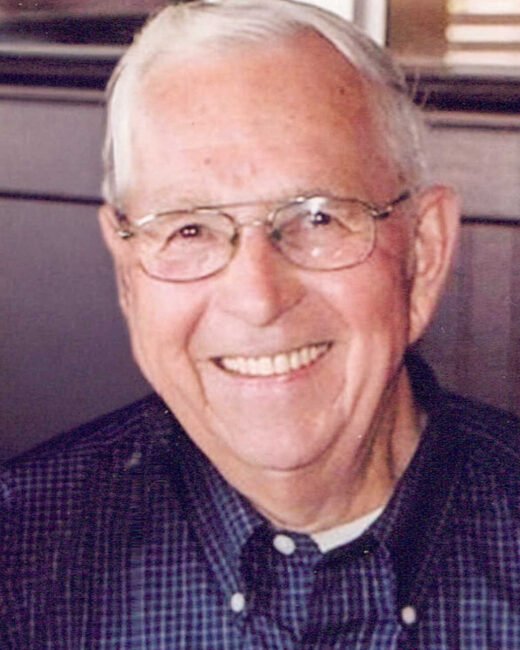 Smiling elderly man with glasses and checked shirt