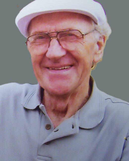 Elderly man smiling, wearing glasses and a cap.