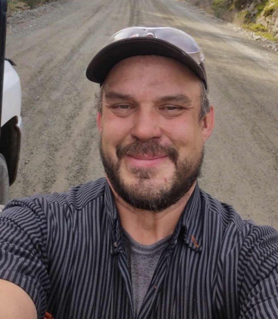 Man smiling on a dirt road