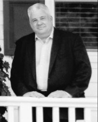 Man in suit standing on porch