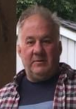 Man in checkered shirt outdoors