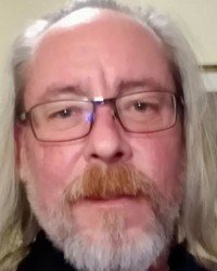 Man with glasses and long gray hair.