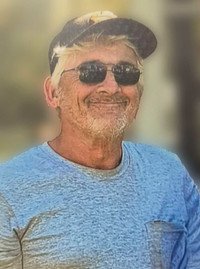 Smiling man wearing sunglasses and cap outdoors