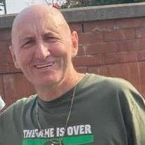 Smiling man in green shirt outdoors