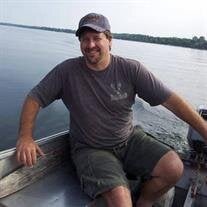 Man smiling while boating on a lake
