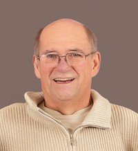Smiling man in beige sweater portrait