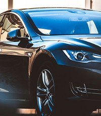 Sleek black car parked in urban area.
