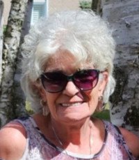 Smiling woman with sunglasses near birch trees