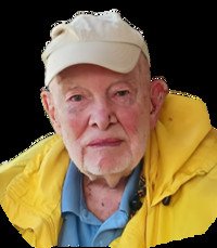 Elderly man wearing yellow jacket and beige cap.