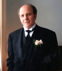 Man in formal suit with roses.