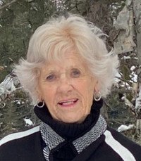 Elderly woman stands outside in snowy forest