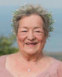 Smiling woman with flower crown outdoors.