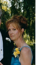 Woman in blue dress with yellow flowers outdoors