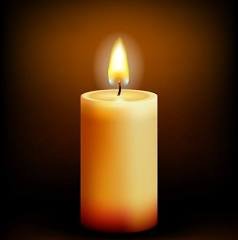 Lit candle in dark background