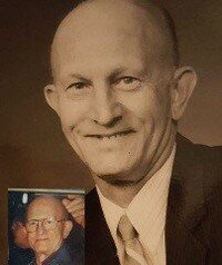 Vintage portrait of a smiling man in a suit.