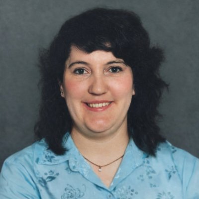 Woman smiling in floral blouse portrait