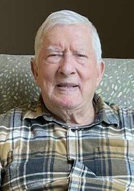 Elderly man smiling in plaid shirt