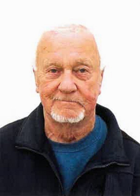 Elderly man with white beard and blue shirt