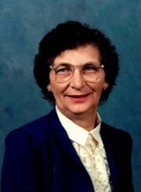 Smiling woman in glasses and blazer portrait