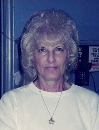 Woman with white hair and white top.