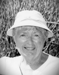 Smiling woman in outdoor hat, black and white photo.