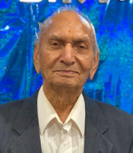 Elderly man in suit against blue background