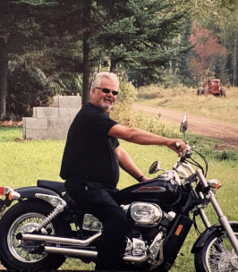 Man riding motorcycle on a rural path