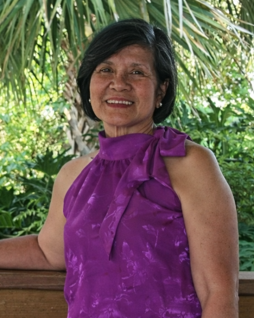 Smiling woman in purple top outdoors