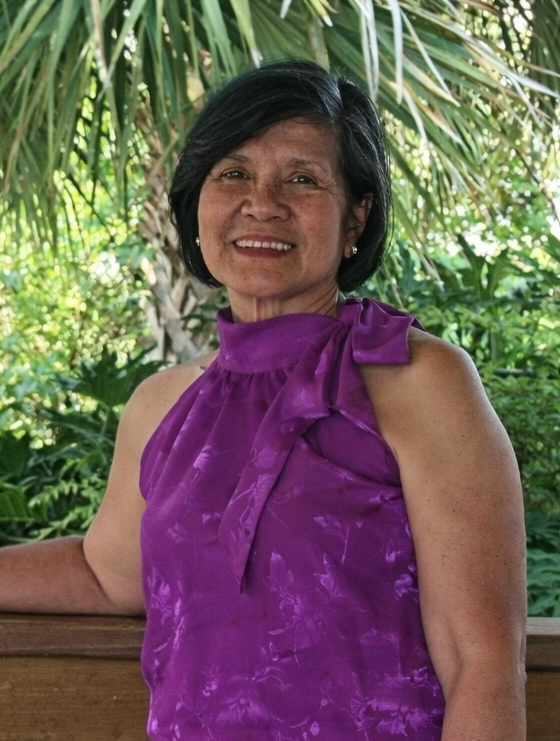 Smiling woman in purple top outdoors