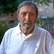 Elderly man in white shirt outdoors