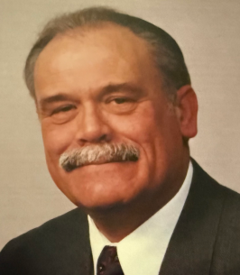 Smiling man in a suit with a mustache