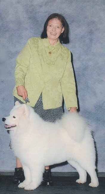 Woman posing with fluffy white dog