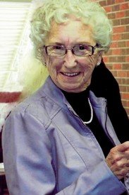 Smiling elderly woman with glasses and curly hair
