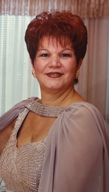 Woman in elegant dress smiling indoors.
